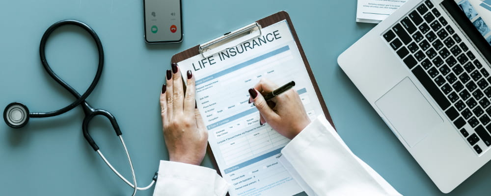 Doctor filling up a life insurance form or final expense form.